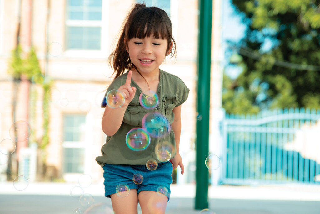 Little Girl blowing bubbles